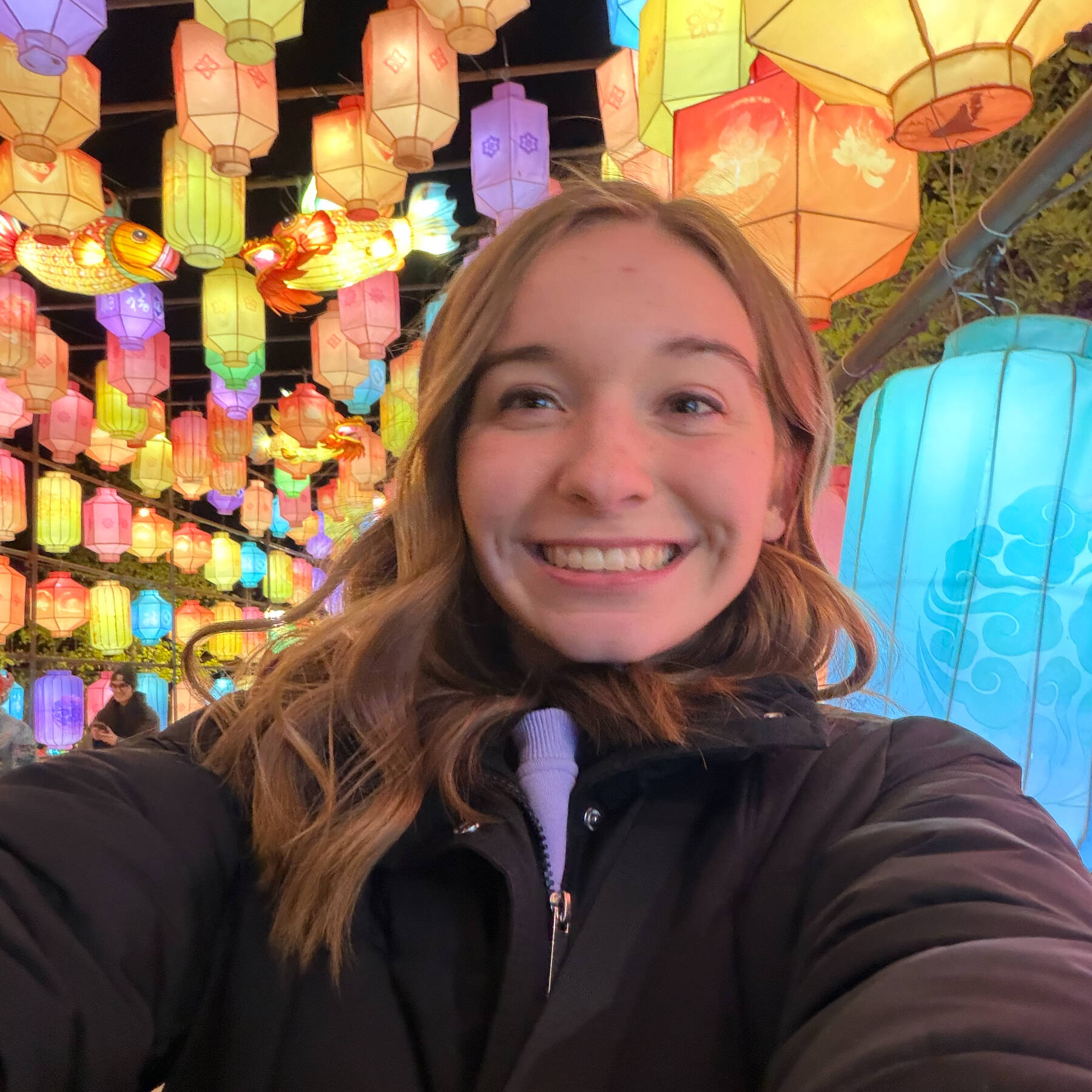 Smiling blonde woman against a background of paper lanterns